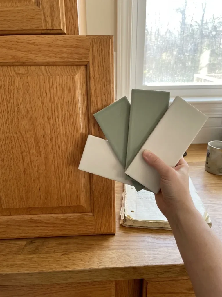 Color theory swatches showing cool tiles against honey oak cabinets