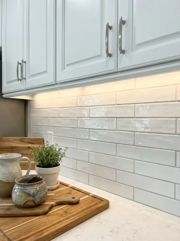 1/3 offset subway tile layout beneath white shaker cabinets