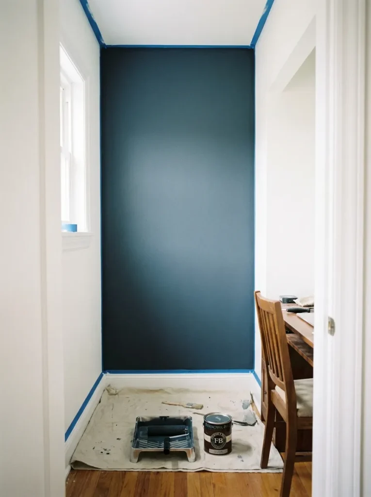 High-contrast slate blue paint inside a reach-in closet desk setup