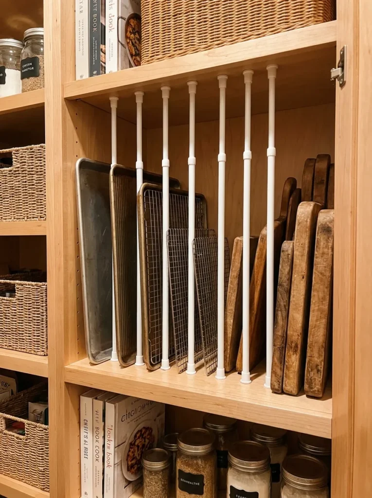 Tension rods used vertically to organize baking sheets in a pantry