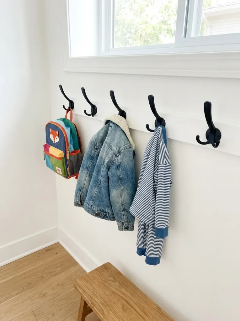 Heavy duty matte black wall hooks installed at kid height