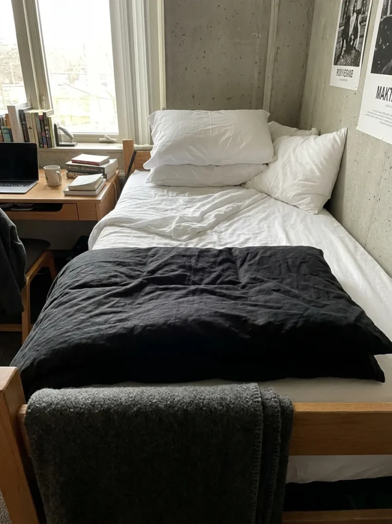 Matte black washed cotton duvet cover styled on a college dorm bed