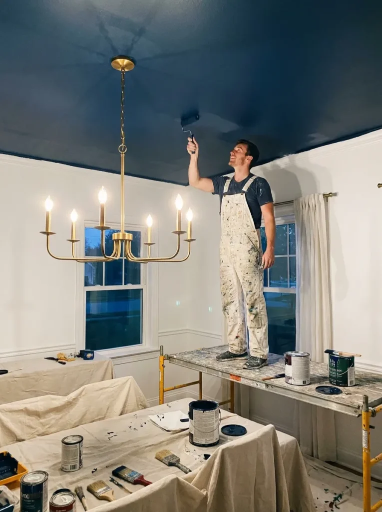 Moody navy blue painted ceiling in an elegant dining room