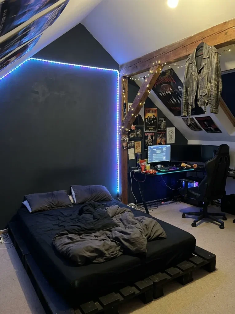 Moody teen boy attic bedroom with dark walls and LED gaming lights