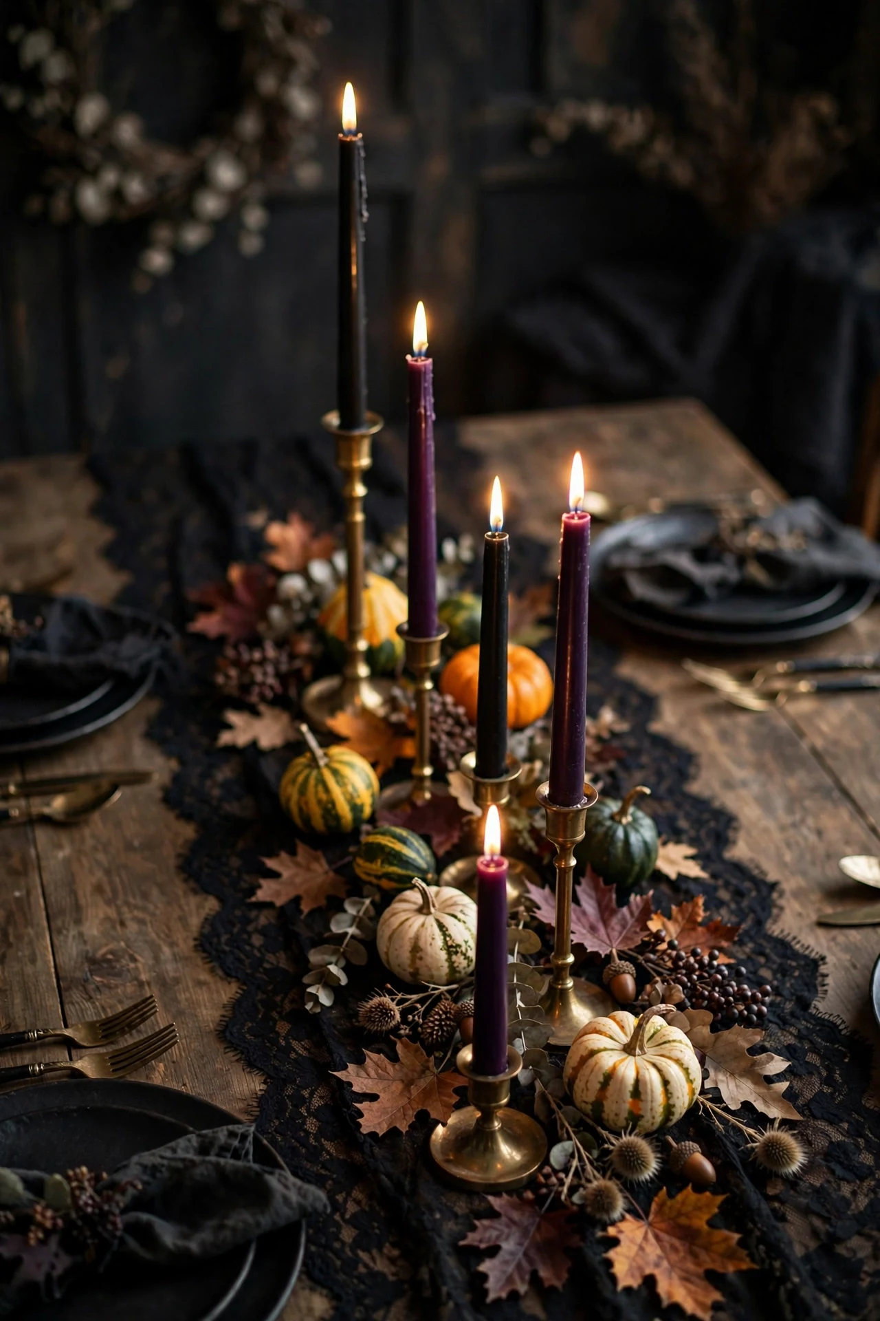 Halloween table with black lace runner and tall taper candles in mixed holders